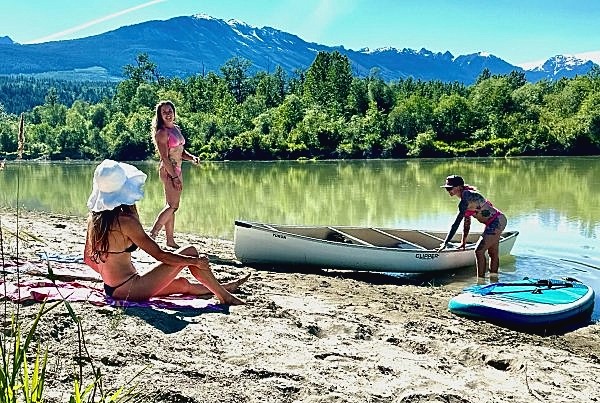 Taking a break on the banks of the Columbia River Women relaxing on the riverbank